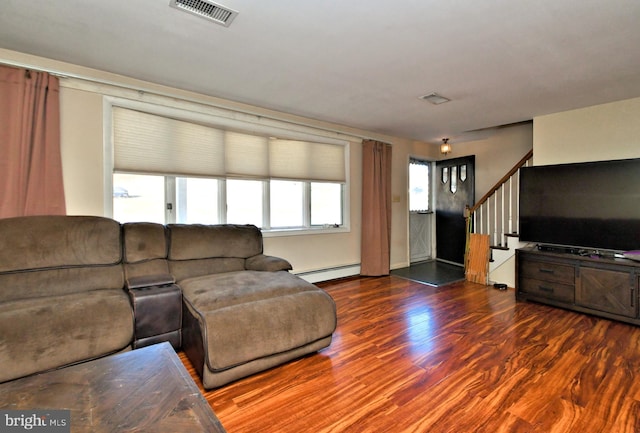 living room with dark wood-type flooring and a baseboard heating unit