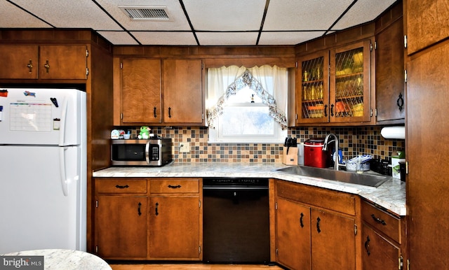 kitchen with backsplash, a paneled ceiling, sink, white refrigerator, and dishwasher