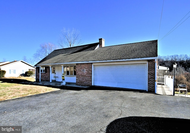 ranch-style home featuring a porch and a garage