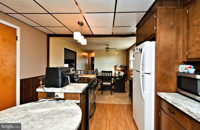 kitchen with light hardwood / wood-style floors, ceiling fan, pendant lighting, electric range, and white fridge