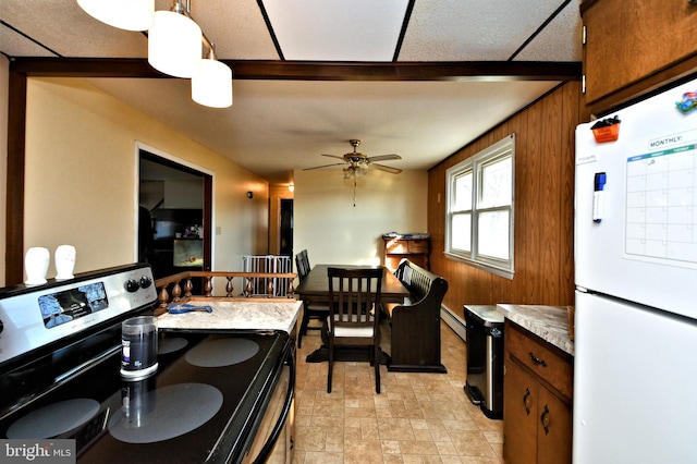 kitchen featuring pendant lighting, black electric range oven, ceiling fan, a baseboard radiator, and white fridge