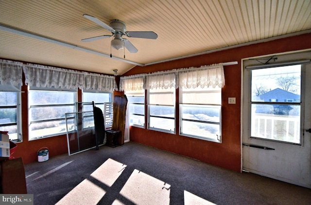 unfurnished sunroom featuring vaulted ceiling, plenty of natural light, and ceiling fan