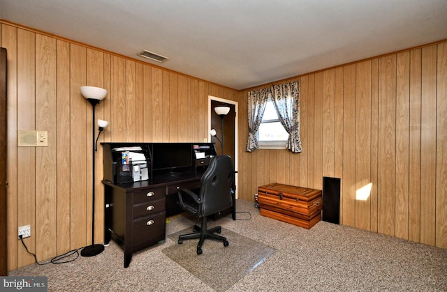 office with carpet floors and wood walls