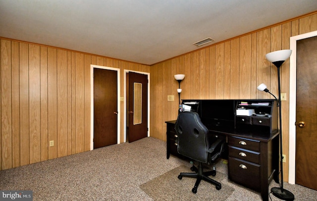 carpeted office featuring wooden walls