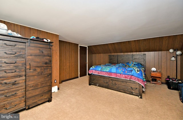 carpeted bedroom featuring vaulted ceiling, baseboard heating, and wooden walls