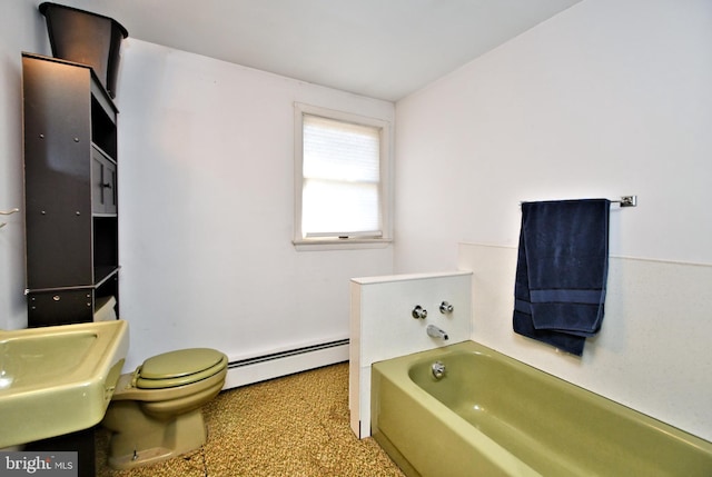 bathroom with toilet, baseboard heating, a tub, and sink