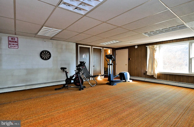 workout room with carpet, a paneled ceiling, and a baseboard heating unit