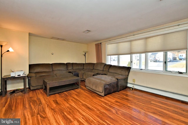 living room with hardwood / wood-style floors and a baseboard heating unit