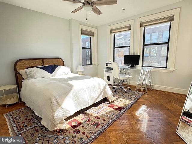 bedroom with ceiling fan and dark parquet floors