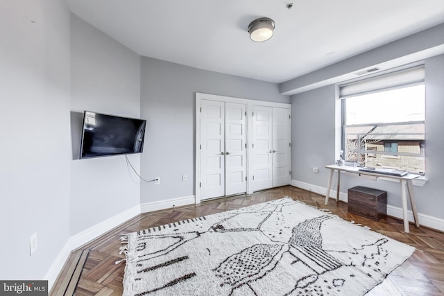 interior space with parquet floors and two closets