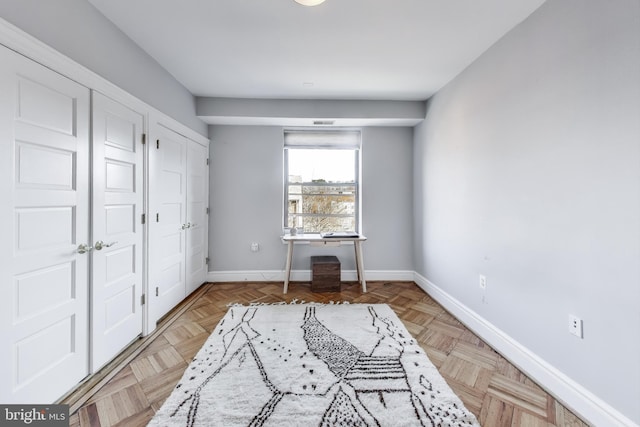 interior space featuring multiple closets and light parquet flooring