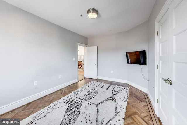 bedroom with light parquet flooring