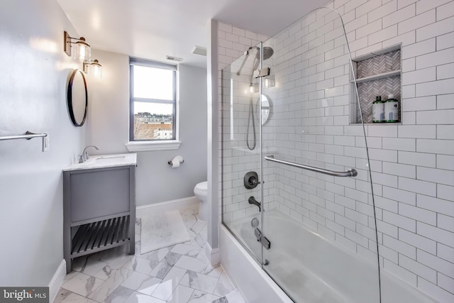 full bathroom featuring vanity, enclosed tub / shower combo, and toilet