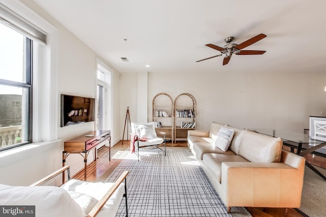 living room featuring hardwood / wood-style flooring and ceiling fan