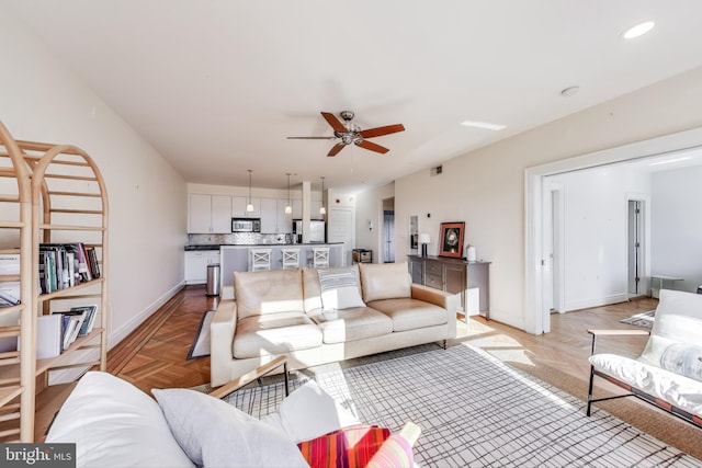 living room featuring ceiling fan and light parquet floors