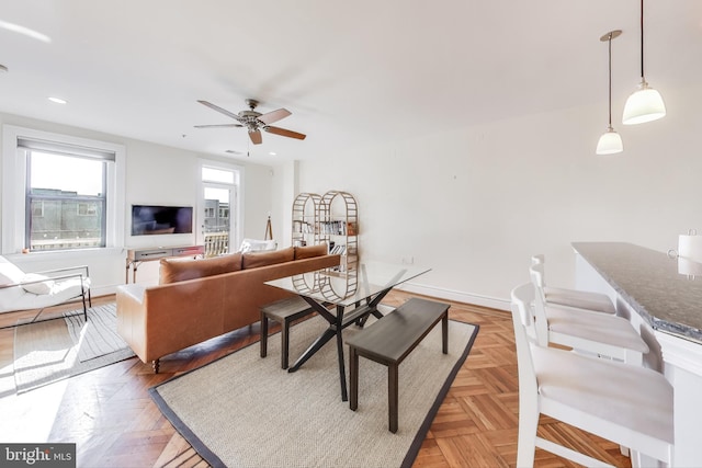 living room with ceiling fan and light parquet flooring