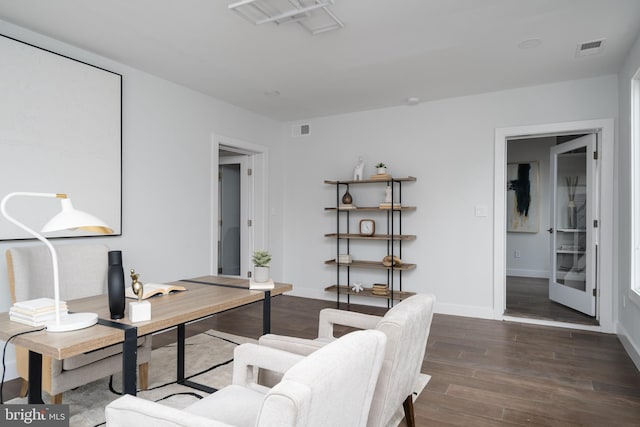 office space featuring dark wood-style floors, visible vents, and baseboards