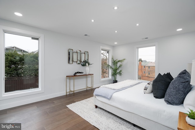 bedroom featuring dark wood-style floors, baseboards, visible vents, and recessed lighting