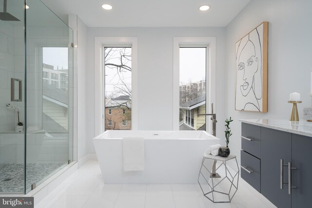 full bath with recessed lighting, a freestanding tub, and a shower stall