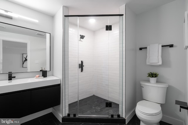 bathroom with visible vents, toilet, a stall shower, vanity, and baseboards