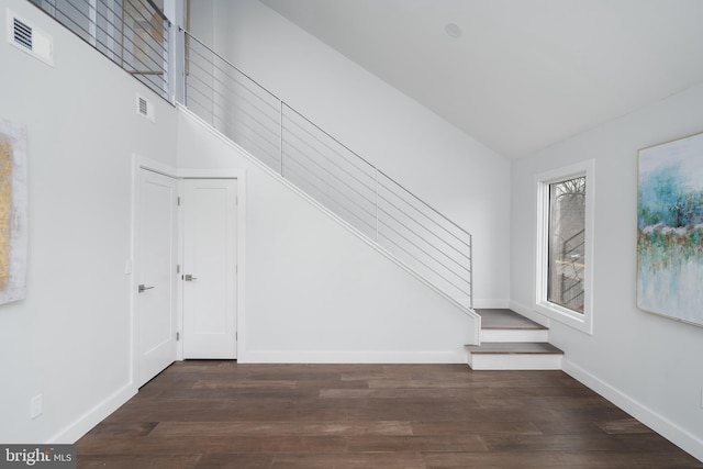 interior space featuring baseboards, visible vents, and wood finished floors