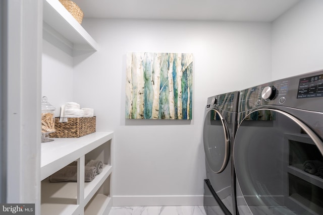 laundry room with laundry area, baseboards, marble finish floor, and separate washer and dryer