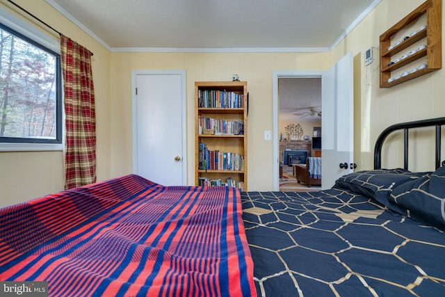 bedroom featuring ornamental molding, a textured ceiling, wooden walls, and a wood stove