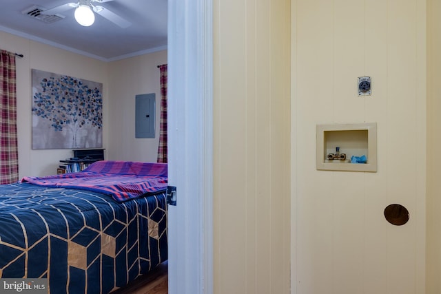 bedroom with hardwood / wood-style floors, ceiling fan, crown molding, and electric panel