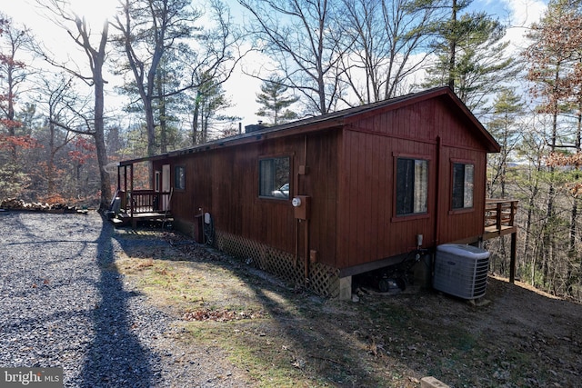 view of side of property with central air condition unit