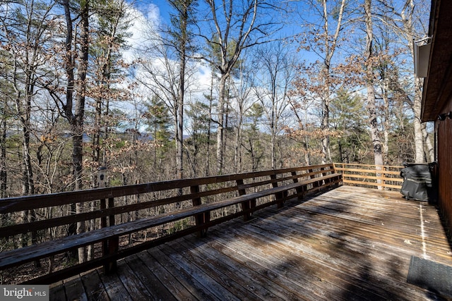 wooden deck featuring a grill