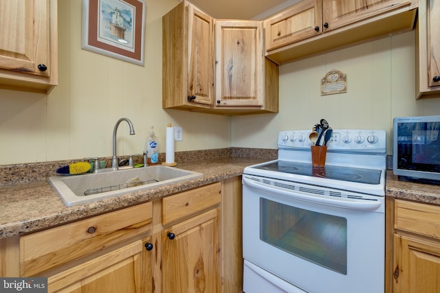 kitchen with white electric range oven, light brown cabinetry, and sink