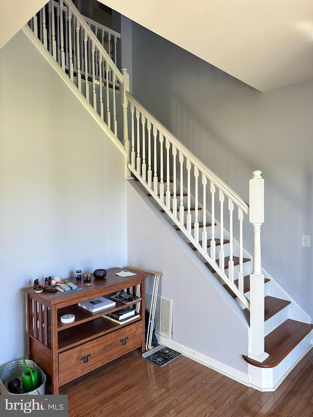 stairway with hardwood / wood-style floors