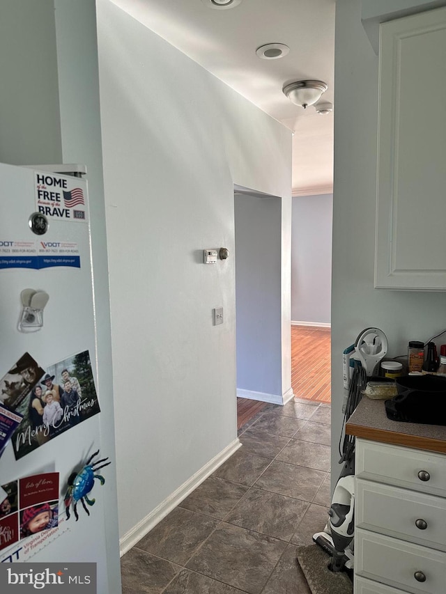 interior space featuring dark hardwood / wood-style floors and white cabinetry