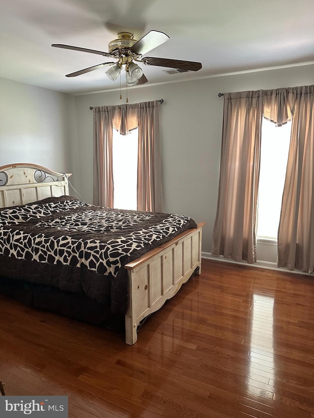 unfurnished bedroom with dark hardwood / wood-style floors and ceiling fan