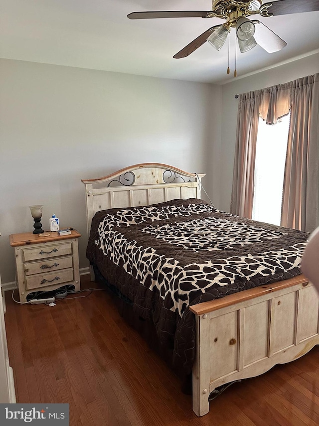 bedroom featuring ceiling fan and dark wood-type flooring