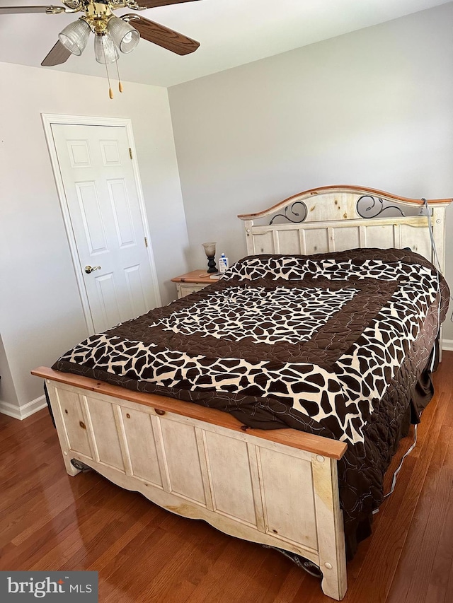 bedroom featuring dark hardwood / wood-style floors and ceiling fan