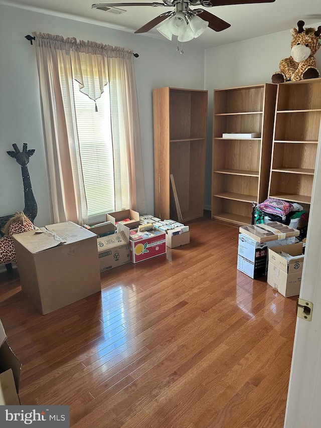 misc room with wood-type flooring and ceiling fan