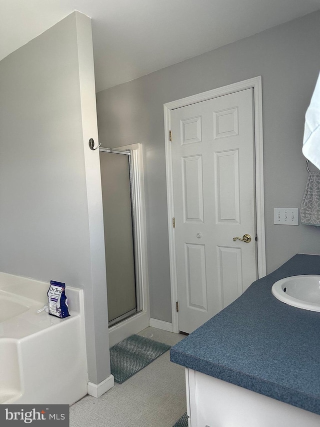 bathroom featuring vanity and an enclosed shower