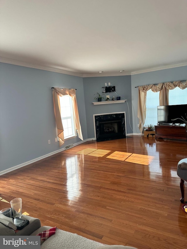 living room featuring hardwood / wood-style flooring and ornamental molding