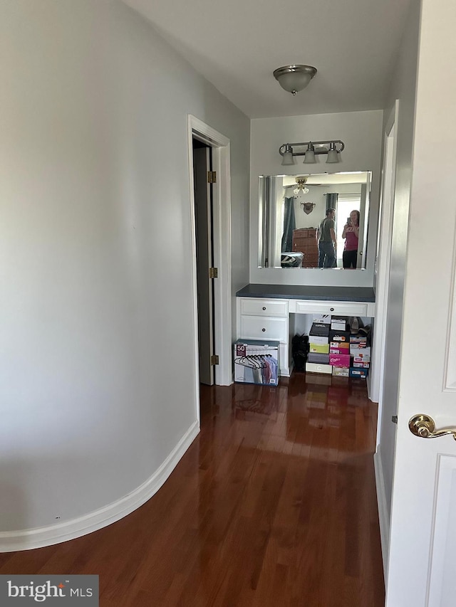 hall with dark wood-type flooring