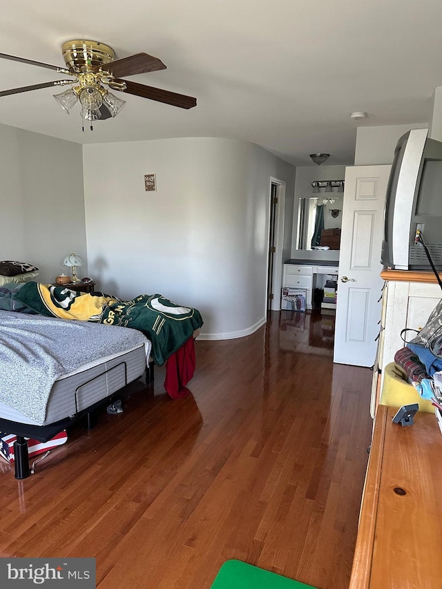 bedroom with ceiling fan and dark wood-type flooring