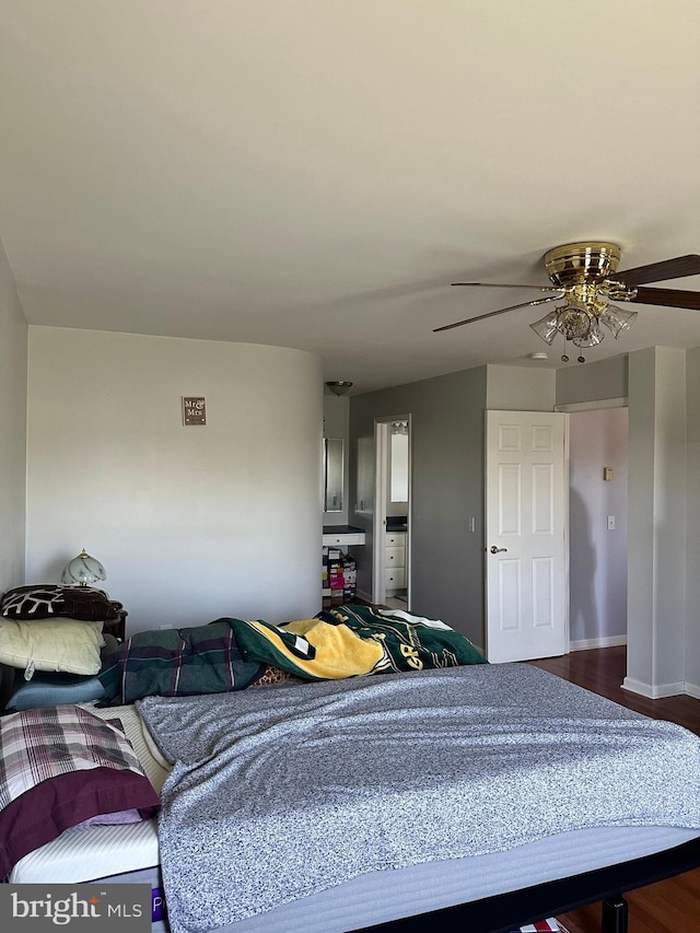 bedroom with dark hardwood / wood-style floors and ceiling fan