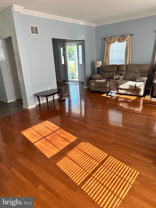 living room featuring hardwood / wood-style floors and crown molding