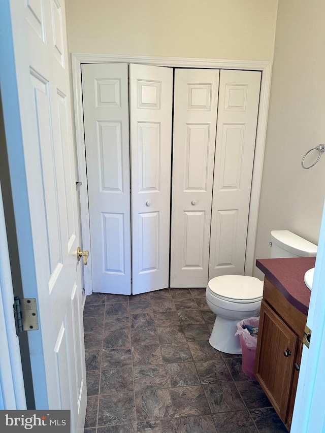 bathroom featuring vanity and toilet