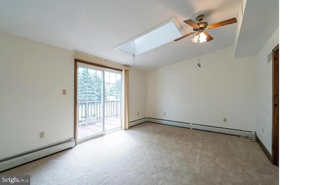 empty room featuring a skylight, ceiling fan, light carpet, and a baseboard heating unit