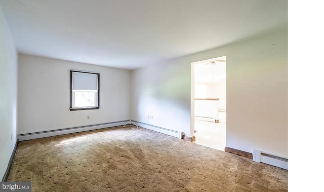 carpeted spare room with a baseboard radiator