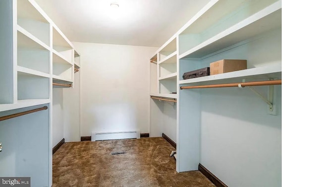 walk in closet featuring dark colored carpet and a baseboard radiator