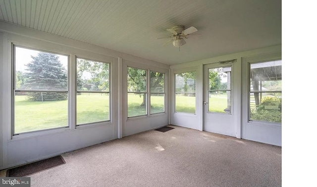 unfurnished sunroom with a wealth of natural light and ceiling fan