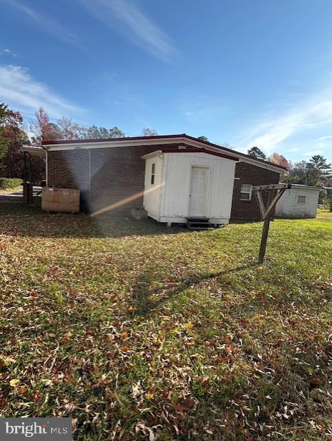 rear view of property with a lawn