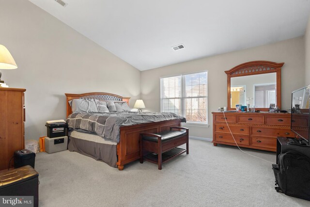 bedroom with lofted ceiling and light carpet